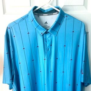 Adidas golf polo blue with repeating Adidas logo.
